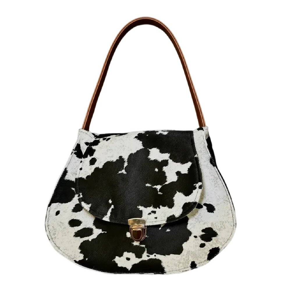 Handmade cow print purse with vegan leather strap and gold clasp